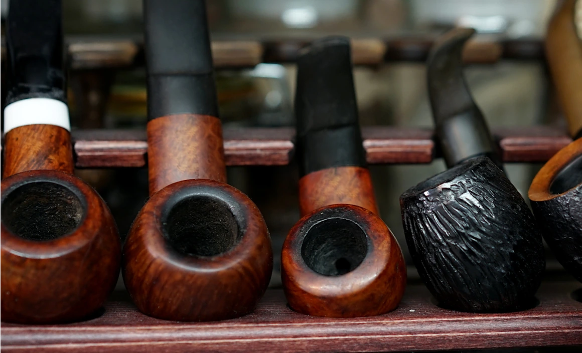 Close-up of artisan-made tobacco pipes on display.