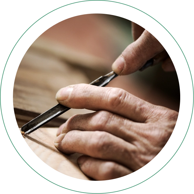 Tobacco pipe artisan using a tool to carve a custom tobacco pipe.